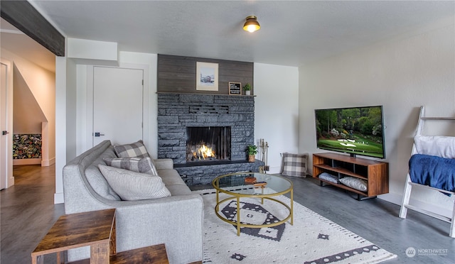 living room featuring a stone fireplace