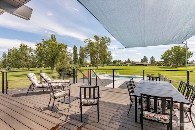 wooden deck featuring a lawn