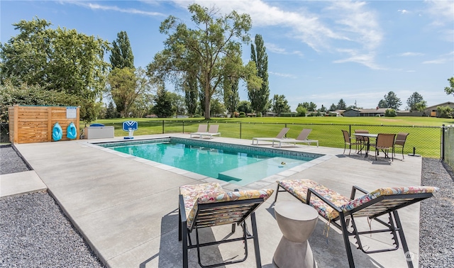 view of swimming pool featuring a lawn and a patio area