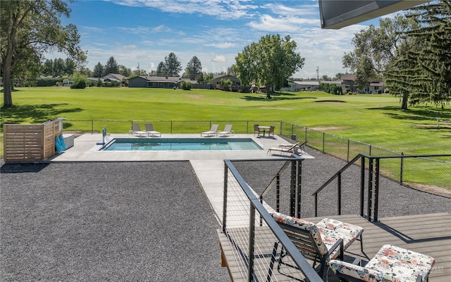 view of swimming pool featuring a patio and a yard