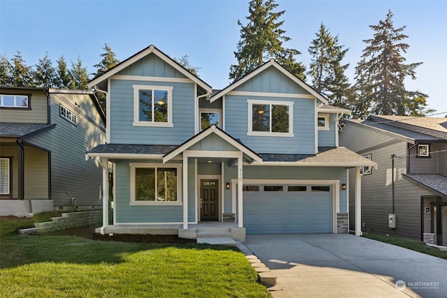 view of front of home with a garage and a front lawn