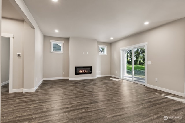 unfurnished living room with dark wood-type flooring