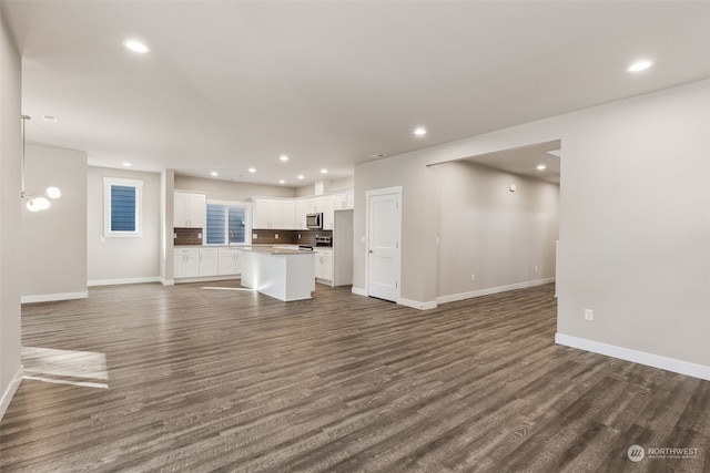 unfurnished living room featuring dark wood-type flooring