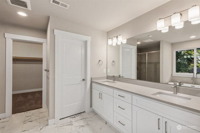 bathroom with walk in shower and vanity