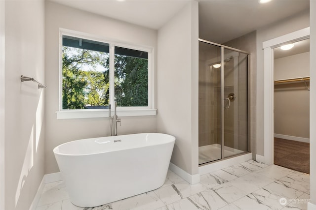 bathroom with shower with separate bathtub