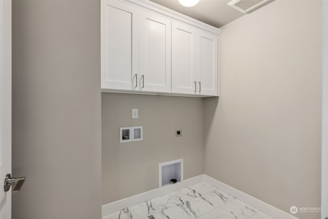 laundry room featuring washer hookup, electric dryer hookup, and cabinets