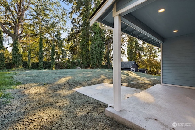 view of yard with a patio and an outbuilding