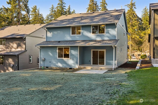 back of property featuring a patio and a lawn