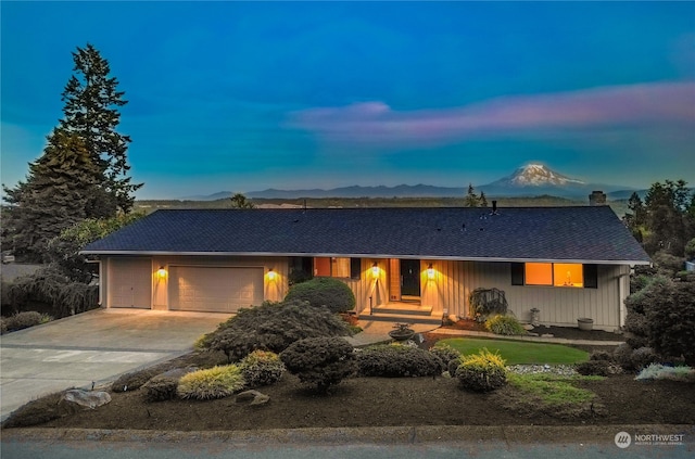 ranch-style house featuring a mountain view and a garage