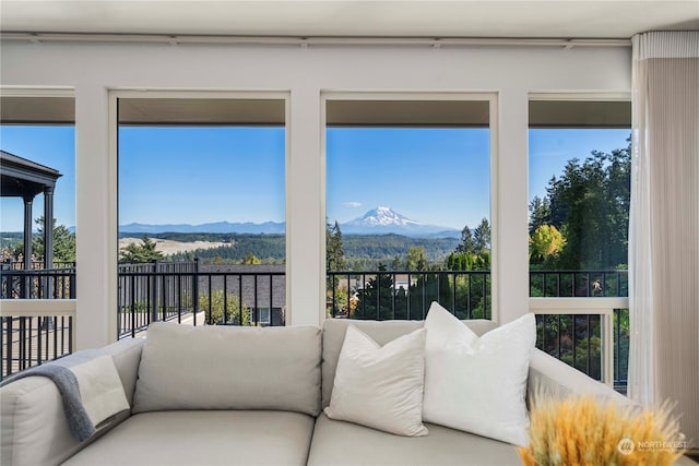 sunroom / solarium with a mountain view and a healthy amount of sunlight