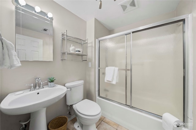 full bathroom featuring combined bath / shower with glass door, sink, toilet, and tile patterned floors