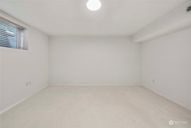 empty room featuring light colored carpet