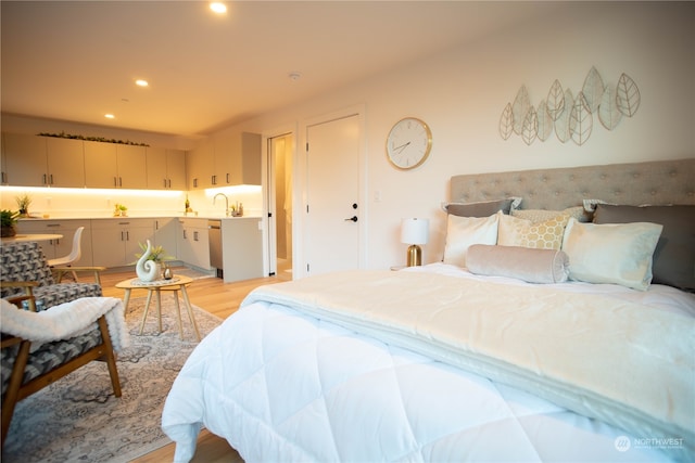 bedroom featuring light hardwood / wood-style flooring and sink