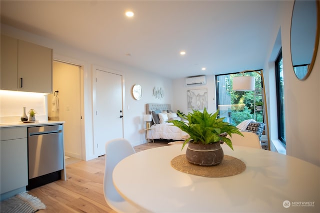 dining area featuring light hardwood / wood-style floors and a wall mounted AC