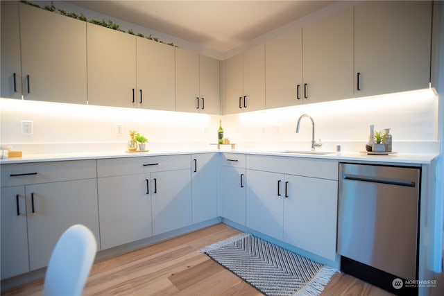 kitchen with dishwasher, light wood-type flooring, and sink