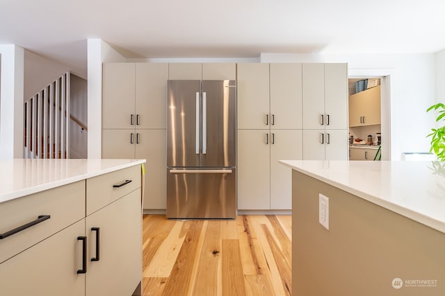 kitchen featuring stainless steel fridge and light hardwood / wood-style floors