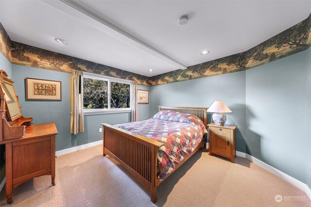 carpeted bedroom with beam ceiling