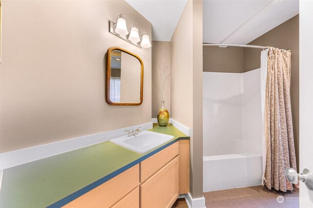 bathroom featuring vanity and shower / bath combo with shower curtain