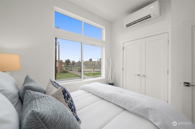 bedroom featuring an AC wall unit and a closet