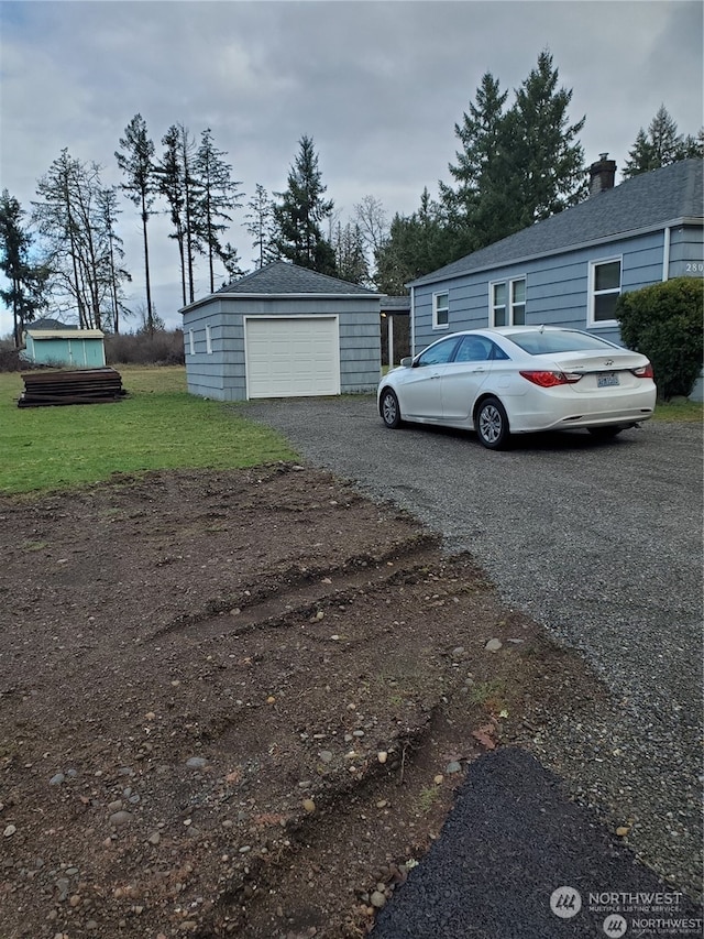 exterior space featuring a yard, an outbuilding, and a garage