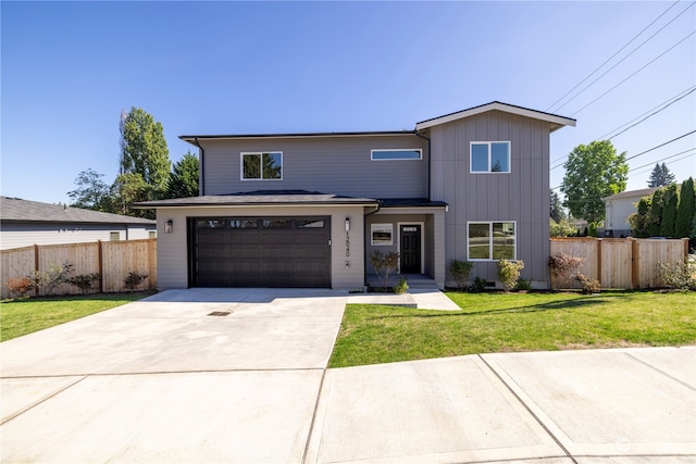 view of front of house with a front yard and a garage