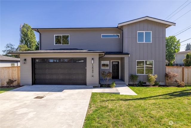 view of front of home with a front lawn and a garage