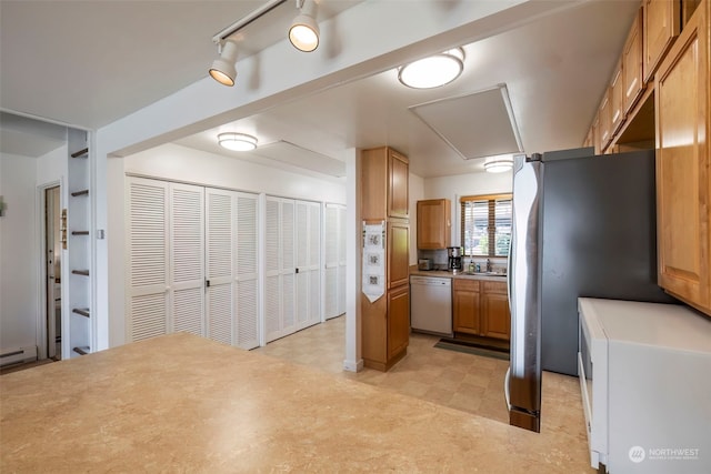 kitchen with stainless steel fridge, white dishwasher, and sink