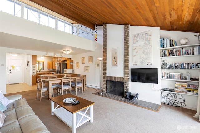 carpeted living room featuring a fireplace, high vaulted ceiling, and wooden ceiling