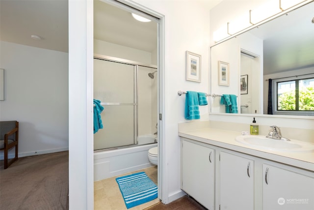 full bathroom with shower / bath combination with glass door, vanity, and toilet