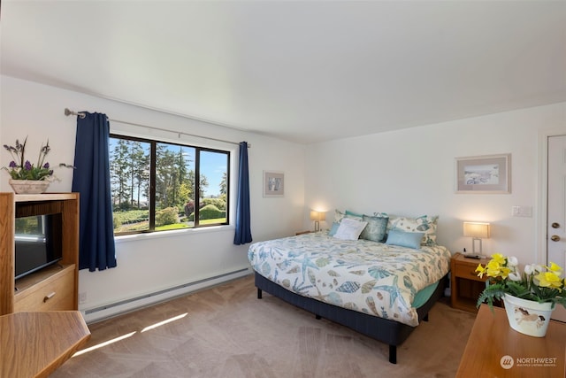 carpeted bedroom with a baseboard heating unit