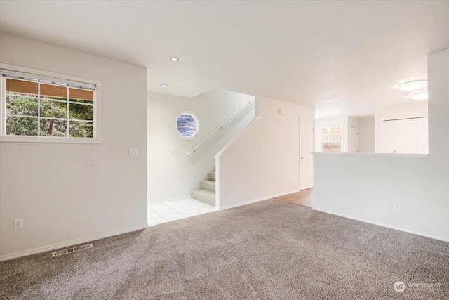 unfurnished living room with light carpet