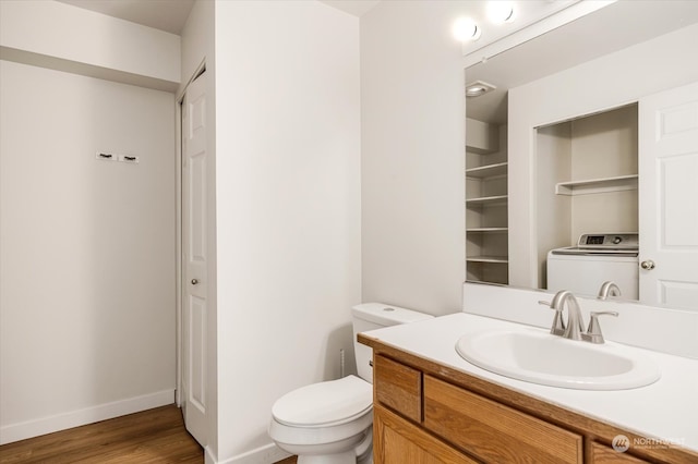 bathroom with wood-type flooring, washer / clothes dryer, vanity, and toilet