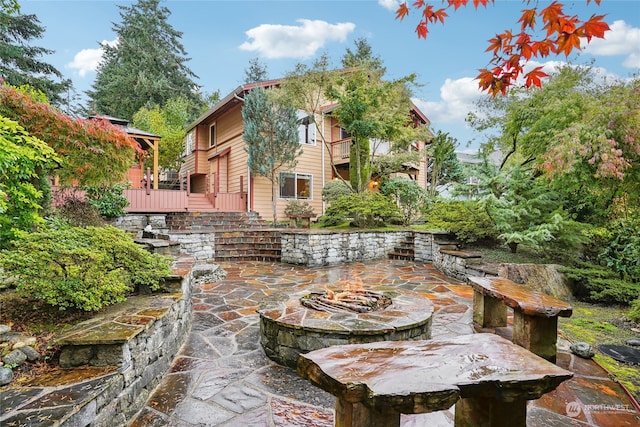 view of patio with a fire pit