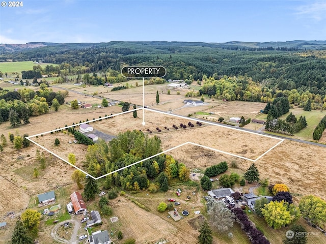 birds eye view of property with a rural view