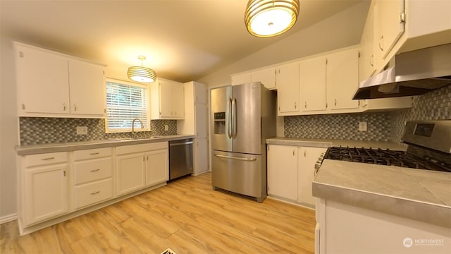 kitchen featuring white cabinets, stainless steel appliances, sink, and lofted ceiling