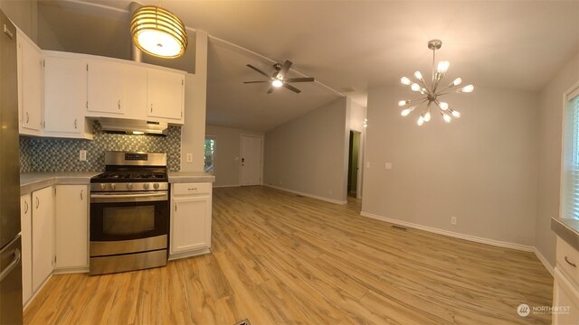 kitchen with white cabinets, stainless steel gas range, ventilation hood, ceiling fan with notable chandelier, and light hardwood / wood-style floors