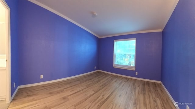 empty room featuring ornamental molding and light hardwood / wood-style floors