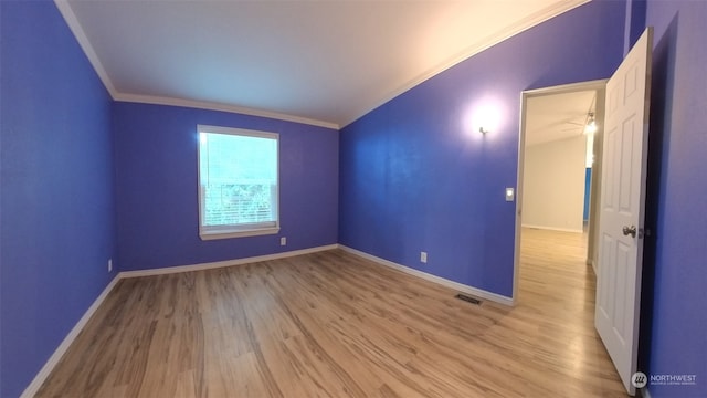 unfurnished room with ornamental molding, lofted ceiling, and light hardwood / wood-style floors