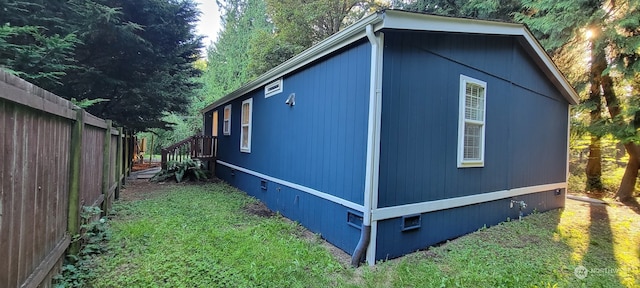 view of side of home featuring a yard