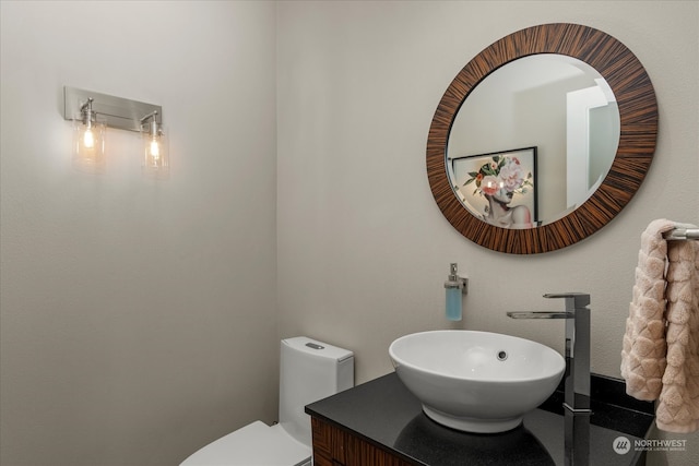 bathroom featuring vanity and toilet