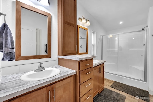 bathroom with vanity, hardwood / wood-style flooring, and an enclosed shower