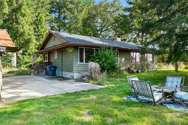 exterior space with a lawn and a patio