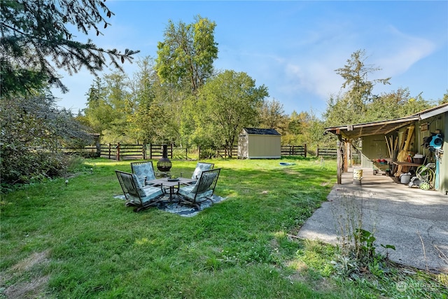 view of yard featuring a storage shed and a patio