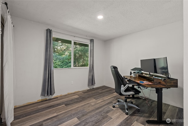 home office featuring a textured ceiling and dark wood-type flooring