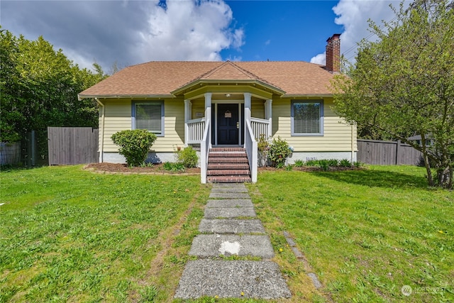 bungalow with a front yard and covered porch