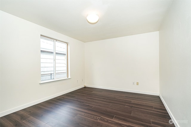 spare room featuring dark wood-type flooring