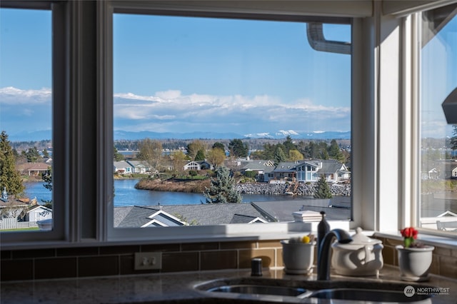 interior space featuring a water view and sink