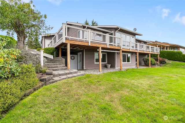 back of property featuring a lawn and a deck