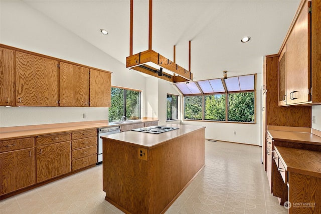 kitchen featuring dishwasher, a center island, vaulted ceiling, and stainless steel gas cooktop