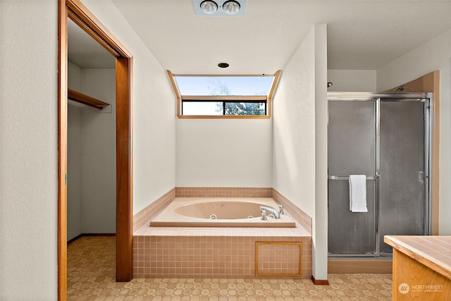 bathroom featuring vanity and independent shower and bath